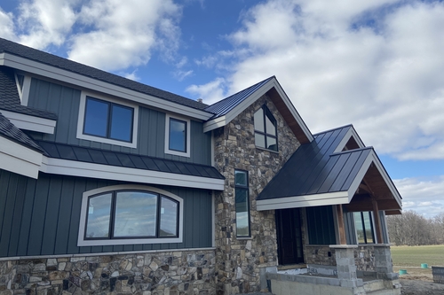 Siding replacement in Pinckney completed by Wilderness Construction crew